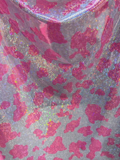 Cow design w/silver/pink on shattered glass New metallic hologram nylon spandex 4-way stretch 58/60” Sold by the YD. Ships worldwide