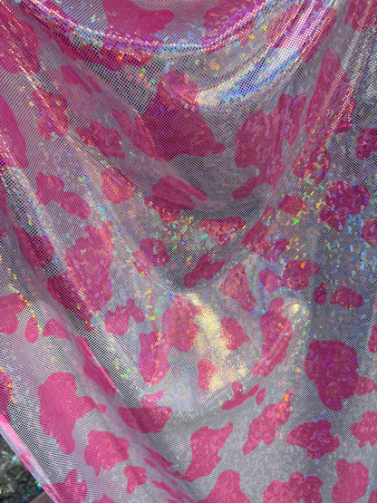 Cow design w/silver/pink on shattered glass New metallic hologram nylon spandex 4-way stretch 58/60” Sold by the YD. Ships worldwide