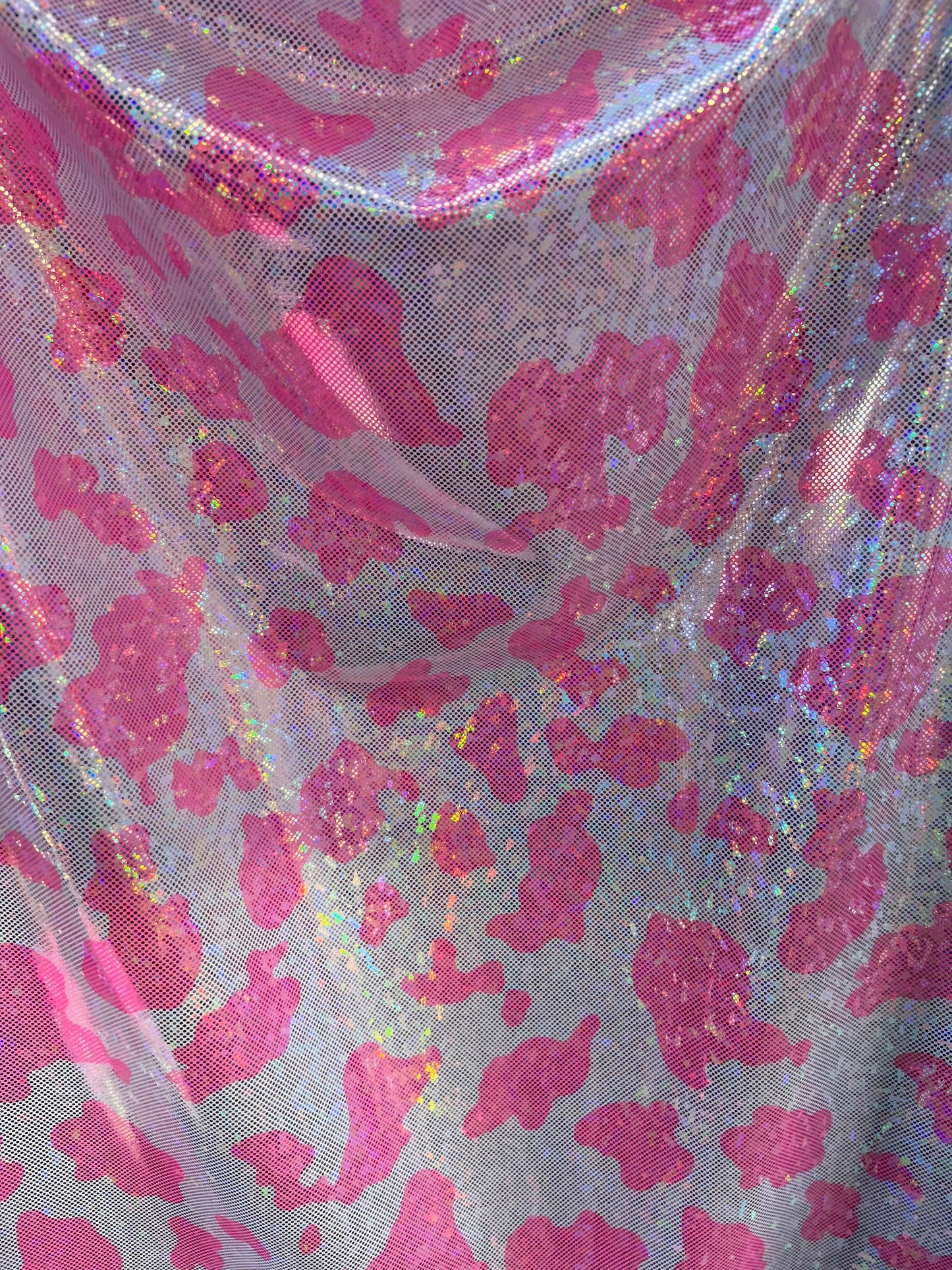 Cow design w/silver/pink on shattered glass New metallic hologram nylon spandex 4-way stretch 58/60” Sold by the YD. Ships worldwide