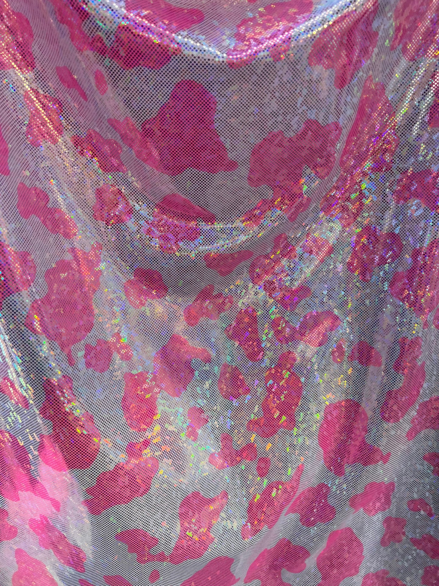 Cow design w/silver/pink on shattered glass New metallic hologram nylon spandex 4-way stretch 58/60” Sold by the YD. Ships worldwide