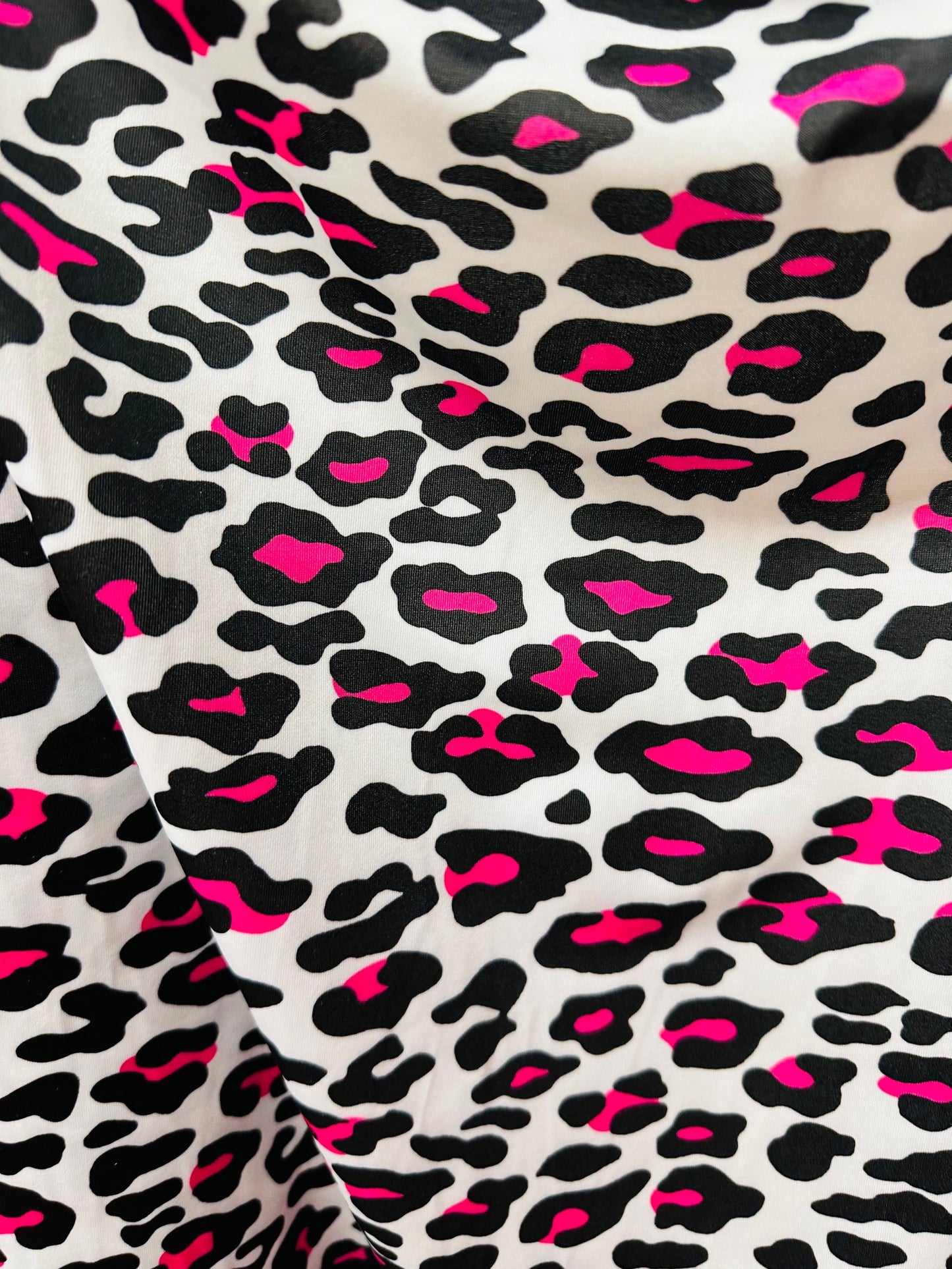 Exotic Leopard design white/Neon pink print on great quality of nylon spandex 4-way stretch 58/60” Sold by the YD. Ships worldwide from LA