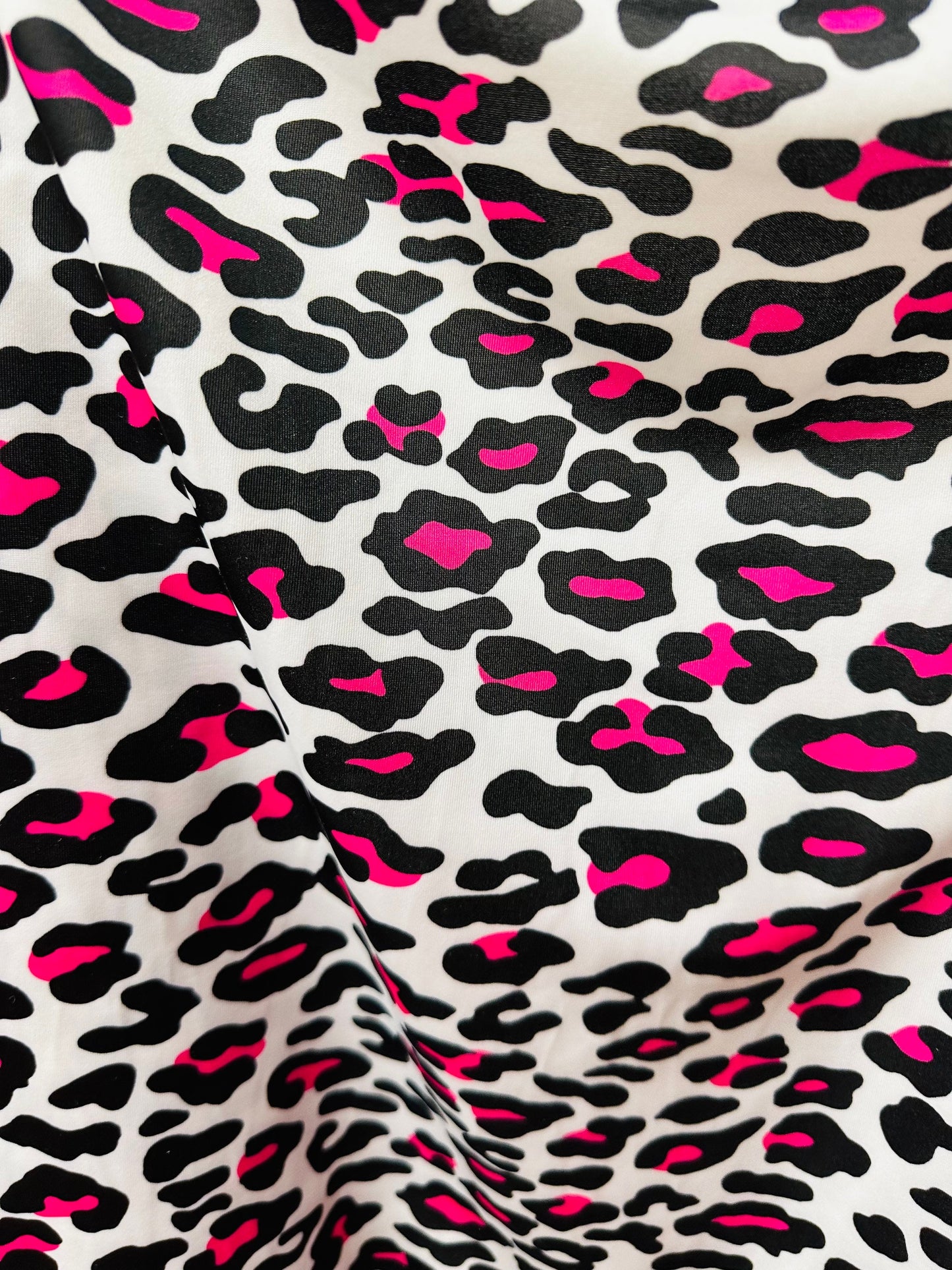 Exotic Leopard design white/Neon pink print on great quality of nylon spandex 4-way stretch 58/60” Sold by the YD. Ships worldwide from LA