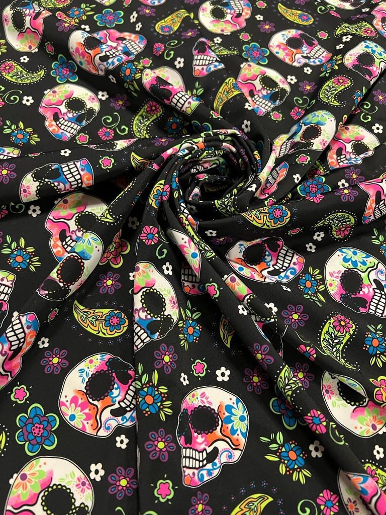 Skulls and paisley design Black/Multicolor print on best quality of nylon spandex 4-way stretch 58/60” Sold by the YD.