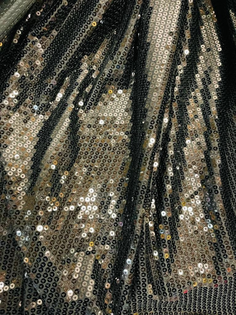 Shiny black sequins 2 designs #1 Disco sequins #2 cosmic glitz sequins both embroidered on stretch mesh 2-way stretch 55/57” Sold by the YD.