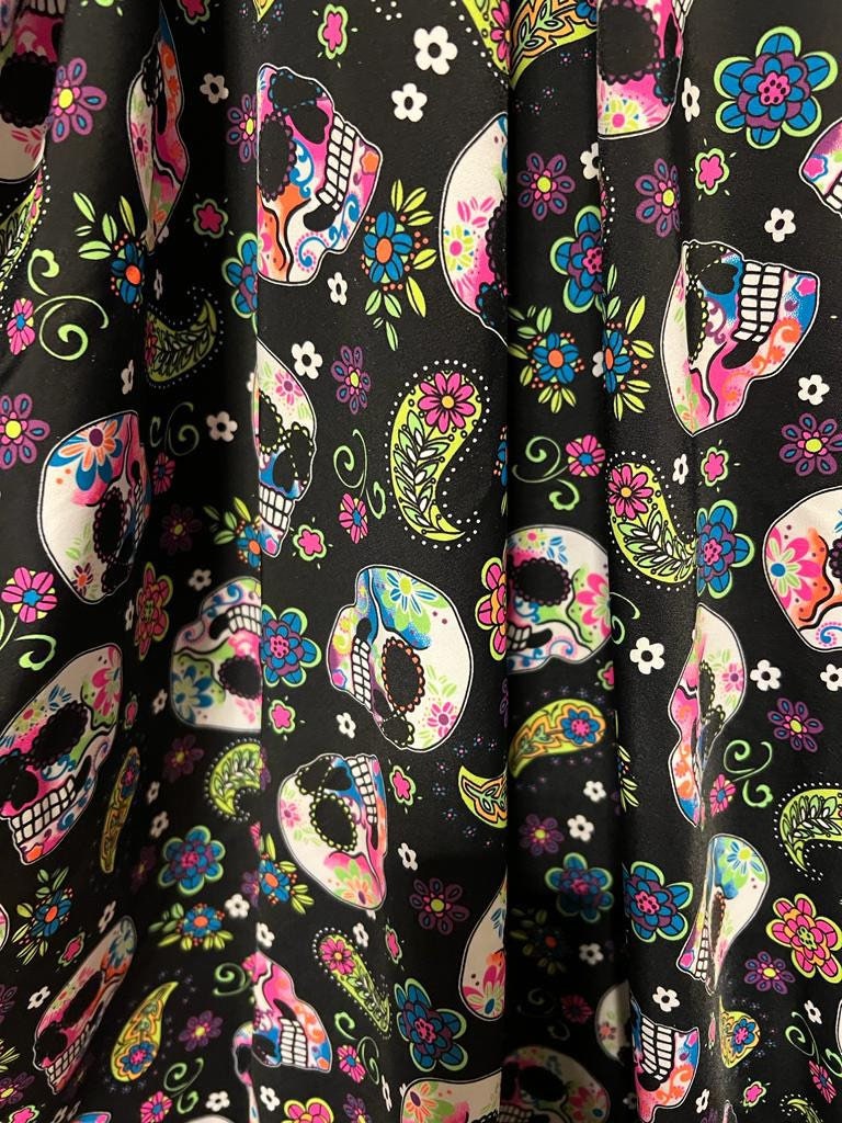 Skulls and paisley design Black/Multicolor print on best quality of nylon spandex 4-way stretch 58/60” Sold by the YD.