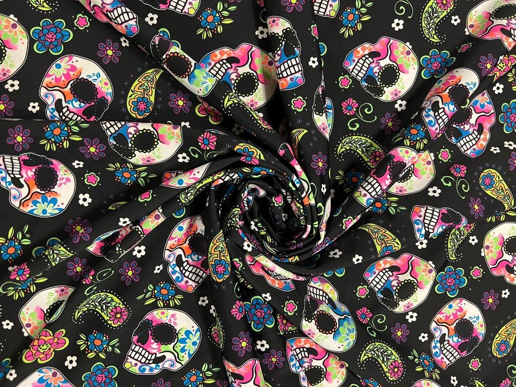 Skulls and paisley design Black/Multicolor print on best quality of nylon spandex 4-way stretch 58/60” Sold by the YD.