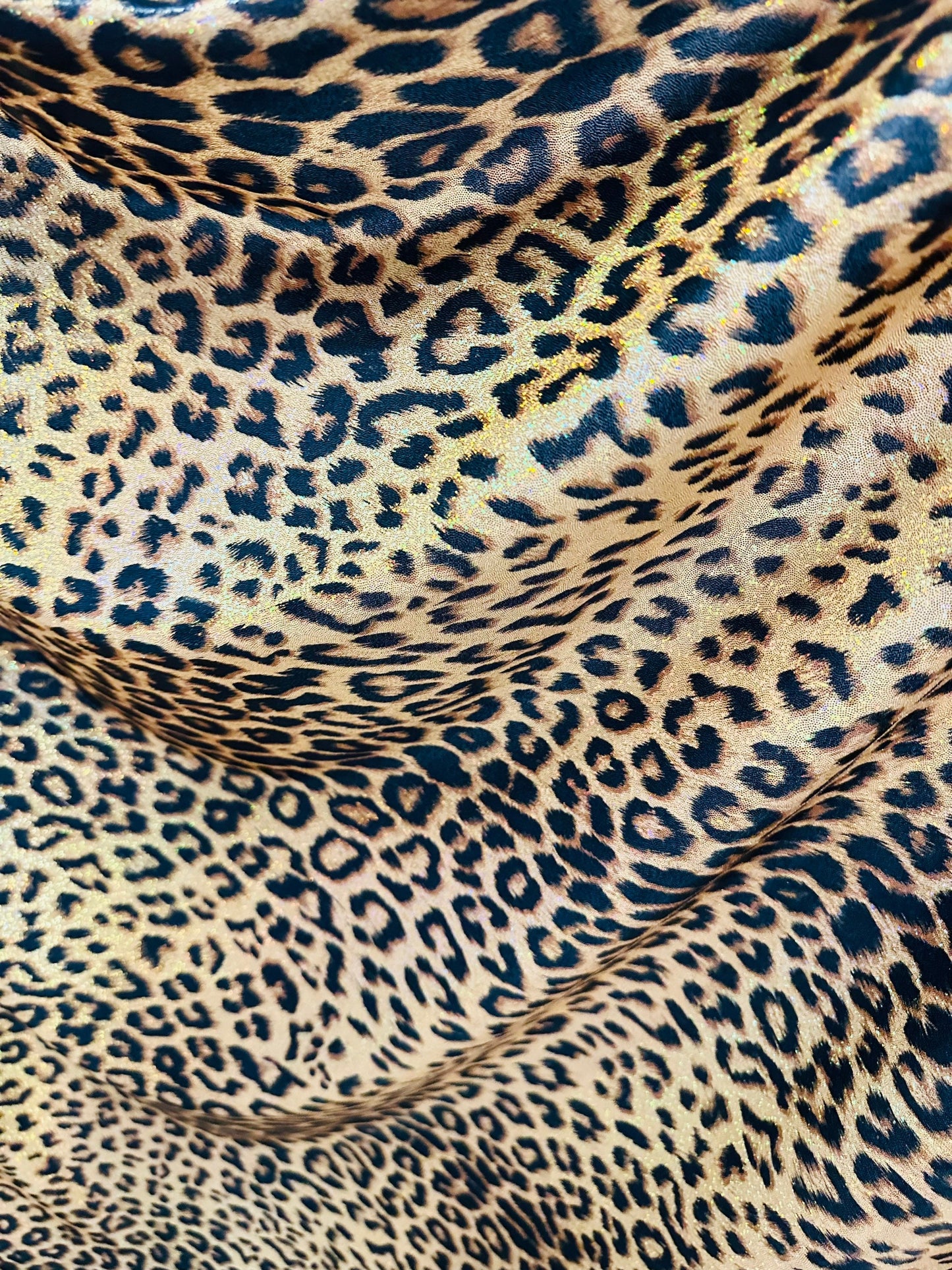 Exotic Jaguar design exotic on hologram metallic nylon spandex with all over Gold/Bronze 4-way stretch 58/60”