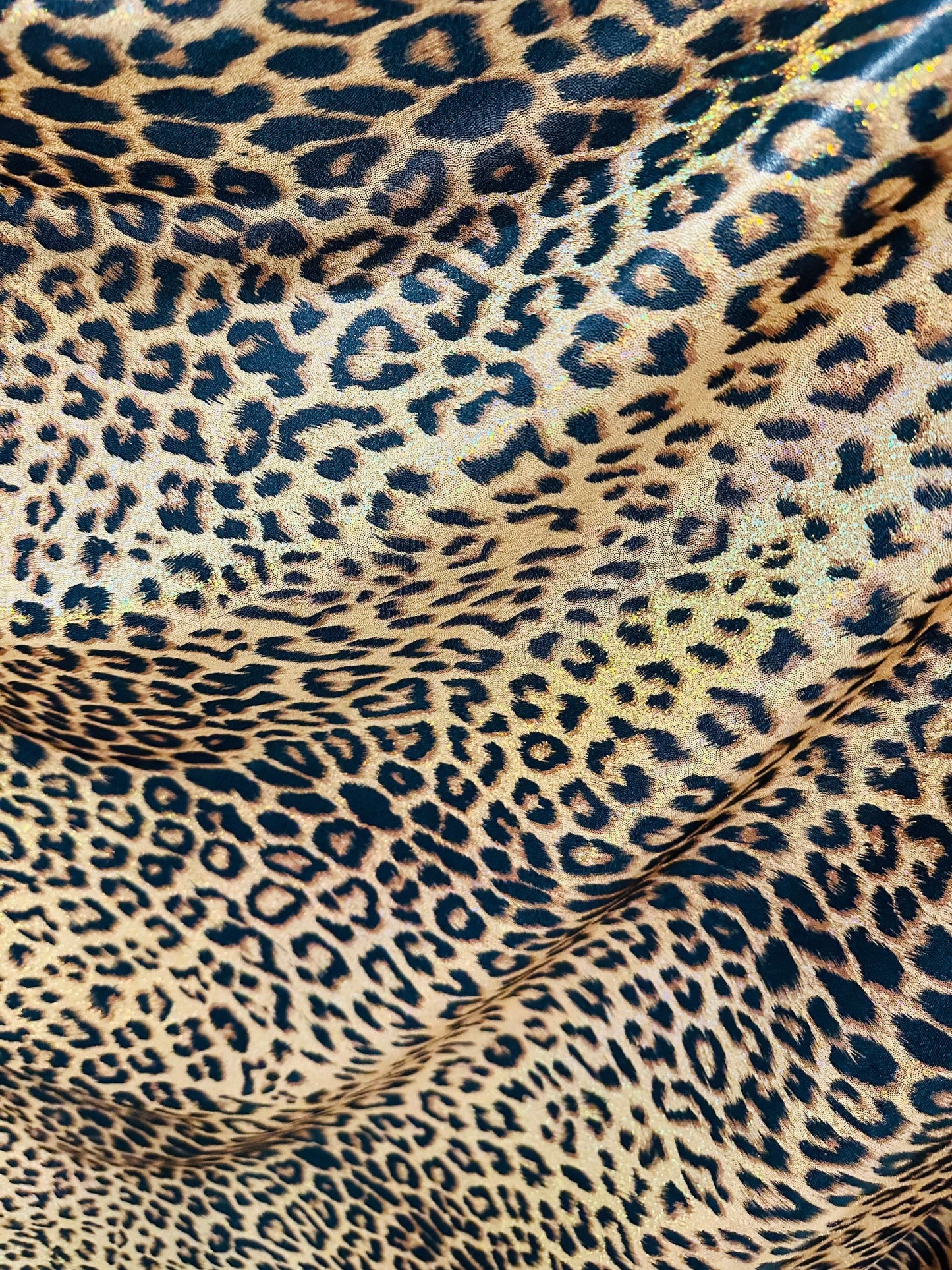 Exotic Jaguar design exotic on hologram metallic nylon spandex with all over Gold/Bronze 4-way stretch 58/60”