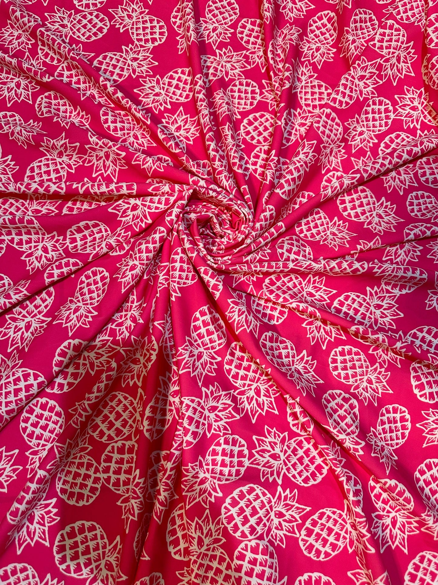 Tropical Pineapple design pink/white print on best quality of nylon spandex 4-way stretch 58/60” Sold by the YD.